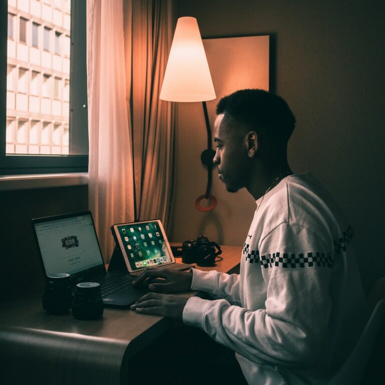 macbook pro on black leather couch