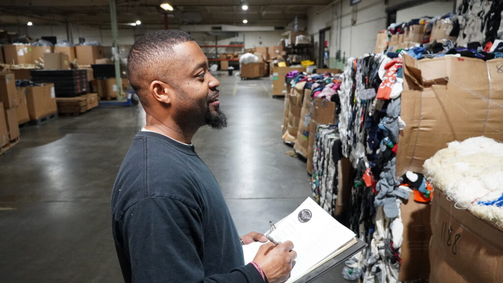 Herron, Warehouse and Logistics Manager, takes inventory of incoming textile waste.